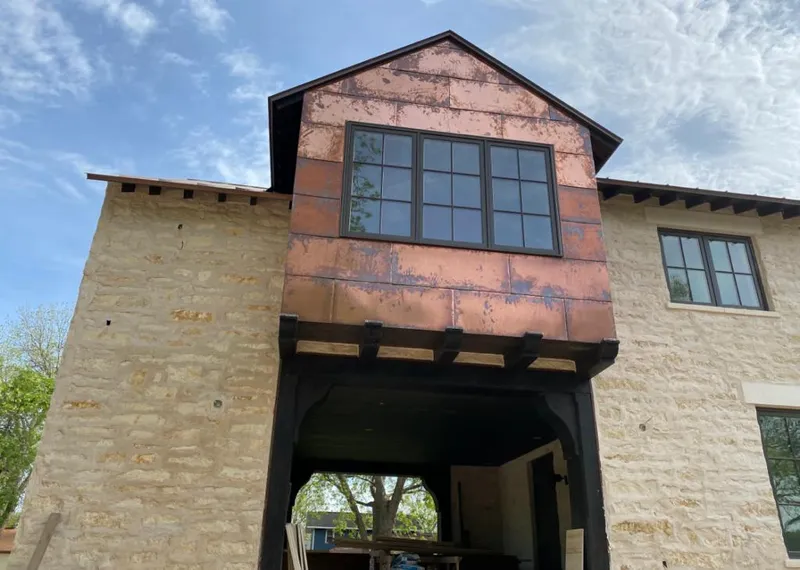Copper metal panel facade on a stone building for Roof Repair in Fish Hawk