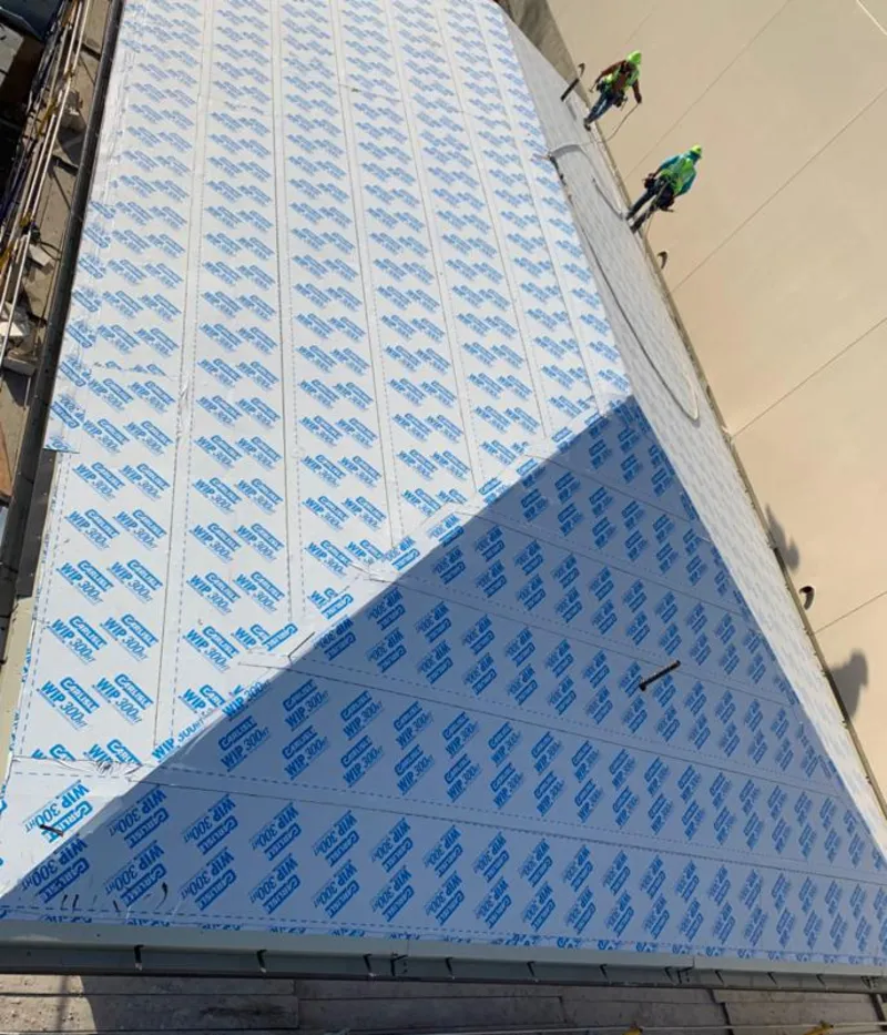Professional roofers installing underlayment on a metal roof in Fish Hawk